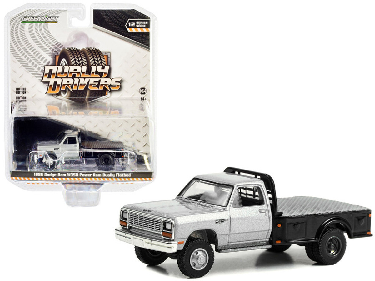 Greenlight 1/64 Dually Drivers Series 12- 1985 Dodge Ram W350 Power Ram Dually Flatbed in Silver 46120-B - Thumbnail