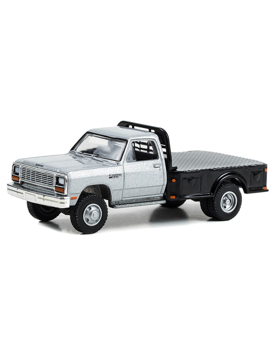 Greenlight 1/64 Dually Drivers Series 12- 1985 Dodge Ram W350 Power Ram Dually Flatbed in Silver 46120-B - Thumbnail