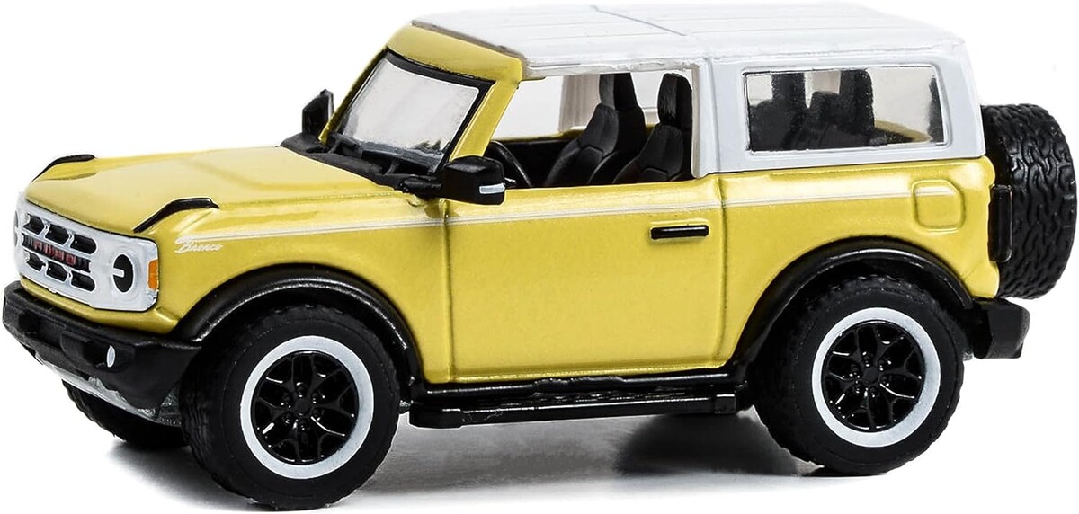 Greenlight 1/64 Showroom Floor Series 3- 2023 Bronco 2-Door Heritage Edition - Yellowstone Metallic con techo blanco Oxford 68030-D - Thumbnail